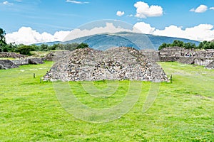 Ruins of the architecturally significant Mesoamerican pyramids and green grassland located at at Teotihuacan, an ancient