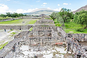 Ruins of the architecturally significant Mesoamerican pyramids and green grassland located at at Teotihuacan, an ancient