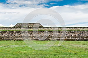 Ruins of the architecturally significant Mesoamerican pyramids and green grassland located at at Teotihuacan, an ancient