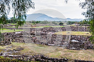 Ruins of the architecturally significant Mesoamerican pyramids and green grassland located at at Teotihuacan, an ancient