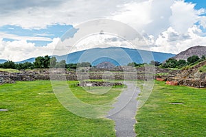 Ruins of the architecturally significant Mesoamerican pyramids and green grassland located at at Teotihuacan, an ancient