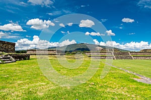 Ruins of the architecturally significant Mesoamerican pyramids and green grassland located at at Teotihuacan, an ancient