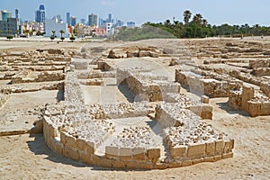 Ruins of the Bahrain Fort with Manama Modern Cityscape in the Backdrop, Bahrain