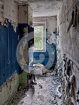 Ruins of bathroom with paint falling off the walls