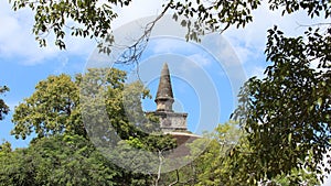 Ruins big and tall buddhist pagoda with leaves frame