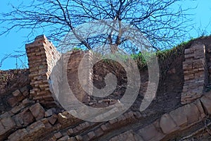 Ruins of brick house in broken rock mountain after earthquake tsunami disaster.