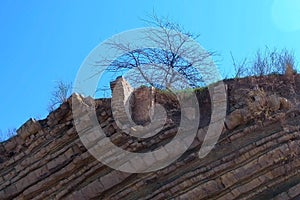 Ruins of brick house in broken rock mountain after earthquake tsunami disaster.