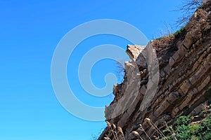 Ruins of brick house in broken rock mountain after earthquake tsunami disaster.