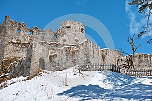 Ruins of castle Ehrenberg in snowy winter by blue sky