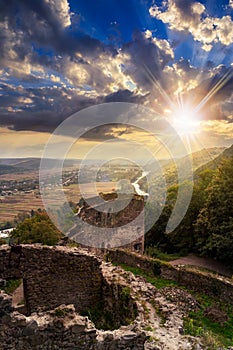 Ruins of castle in mountain at sunset