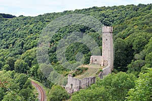 Ruins of the castle Philippsburg on a hill spur above Eifel village of Monreal, Germany photo