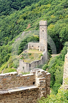 Ruins of the castle Philippsburg on a hill spur above Eifel village of Monreal, Germany