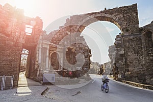 The ruins of the central gate of the ancient city of Side in Turkey in the light of the setting sun