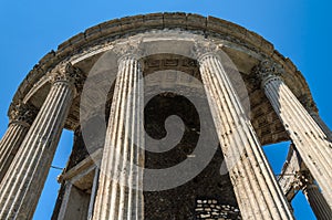 Ruins with columns of the ancient temple of the goddess Vesta in Tivoli, Italy