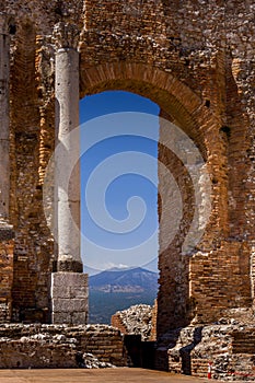 Ruins and columns of antique greek theater in Taormina and Etna