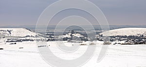 Ruins of Corfe Castle viewed across snow-covered fields