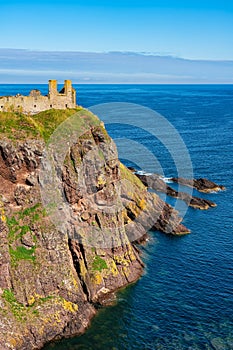 Ruins of Dunnottar Castle atop the cliffs overlooking the sea east of the coast of Scotland.