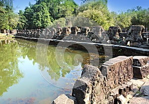 Ruins of a fencing of a sacred reservoir when approaching to the temple Neak Pean near Siem Reap, Cambodia