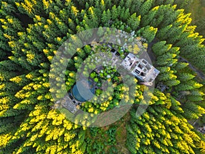 Ruins of former tin mine in the forest from above