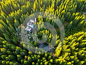 Ruins of former tin mine in the forest from above