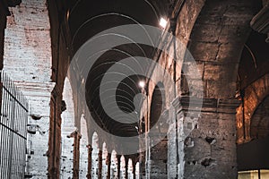 Ruins of the gated arch of the passage at the entrance of the Roman Colosseum in Rome, Italy