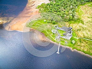 The ruins of historic Kilchurn Castle and jetty on Loch Awe