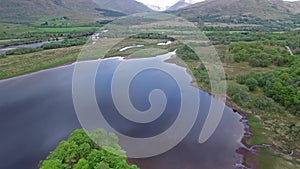 The ruins of historic Kilchurn Castle and jetty on Loch Awe