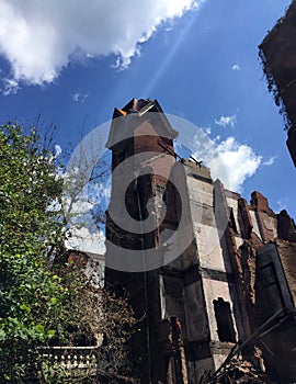 Ruins of large old tower of fire damaged home