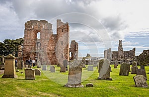The ruins of Lindisfane Priory with Lindisfarne Castle in background, on Holy Island Northumberland, U