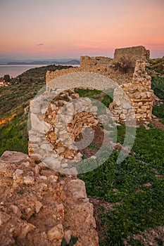 Ruins of a medieval castle in Astros at sunset on the Peloponnese in Greece photo