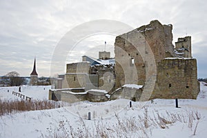 Ruins of the medieval castle of the Livonian knightly award close up in the cloudy March afternoon. Rakvere, Estonia