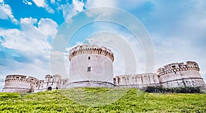 Ruins of medieval old tower of castle under blue sky in Matera Italy