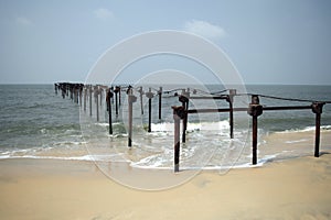 Ruins of an old abandoned sea bridge, sunny day at Alappuzha beach, Kerala, India