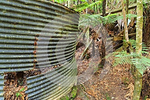 Abandoned gold mining equipment, New Zealand. Cyanide tank and hopper photo