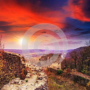 Ruins of an old castle in the mountains at sunset