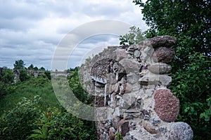 Ruins of old estate buildings made from red brick and stone.