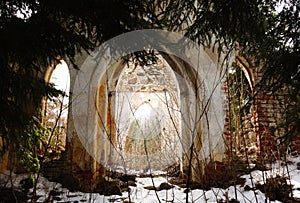 Ruins of the old church in forest in sunset light