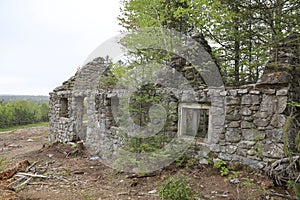 Ruins of an old and forgotten lodge in a field captured during the daytime