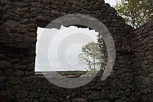 Ruins of an old and forgotten lodge in a field captured during the daytime