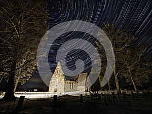 The ruins of an old medieval church and long star trails.