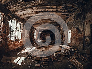 Ruins of old red brick abandoned building inside interior, dark creepy corridor