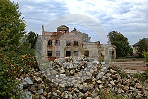 Ruins of an old residential building with heap of stones