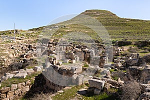 The ruins  of the outer part of the palace of King Herod, against the background of the filled artificial hill in which they are