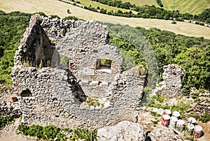 Ruins of Plavecky castle and old barrels with white color, Slovakia