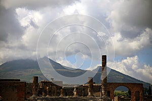 Ruins of Pompeii with the volcano Vesuvius in the cloudy background, Pompeii, Campania, Italy