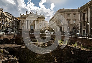Ruins of the Roman Amphitheater at the Stesicoro Square with San Biagio Church on background - Catania, Sicily, Italy photo
