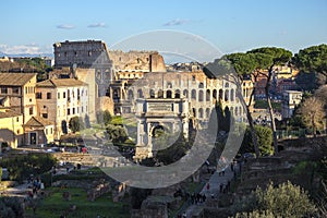 Ruins of Roman forum with Colosseum on background, Italy