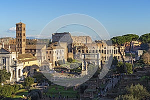 Ruins of Roman forum with Colosseum on background , Rome