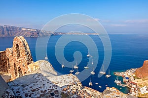 Ruins on Santorini and Sailing Catamarans in the Harbor