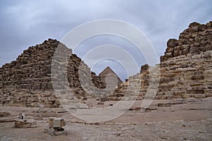 Ruins of the small pyramid of Queen Henutsen with Khafre Pyramids at background, Giza Plateau, Egypt. UNESCO World Heritage